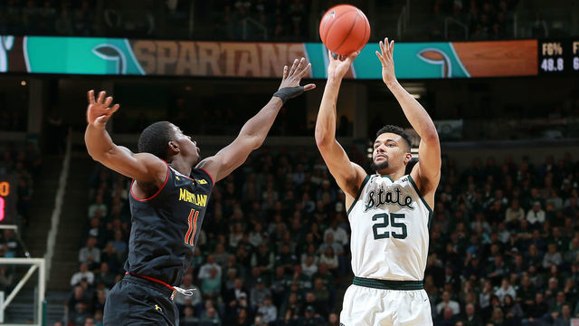 EAST LANSING, MI - JANUARY 21: Kenny Goins #25 of the Michigan State Spartans shoots the ball over Darryl Morsell #11 of the Maryland Terrapins in the second half at Breslin Center on January 21, 2019 in East Lansing, Michigan.
