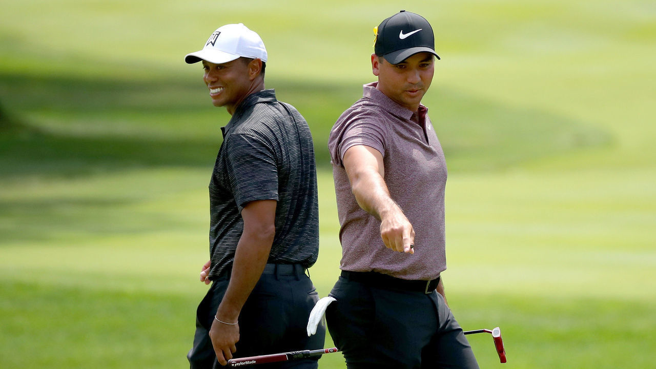 AKRON, OH - AUGUST 03: Jason Day of Australia lines up a putt as Tiger Woods walks by on the third green during World Golf Championships-Bridgestone Invitational - Round Two at Firestone at Firestone Country Club South Course on August 3, 2018 in Akron, Ohio.