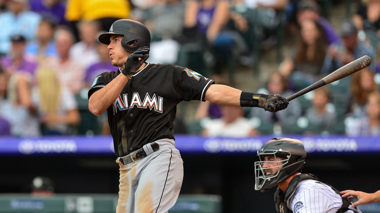 DENVER, CO - JUNE 22: J.T. Realmuto #11 of the Miami Marlins doubles against the Colorado Rockies in the third inning of a game at Coors Field on June 22, 2018 in Denver, Colorado.