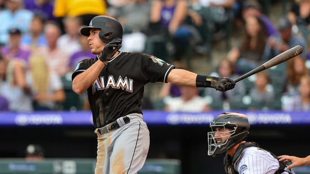 DENVER, CO - JUNE 22: J.T. Realmuto #11 of the Miami Marlins doubles against the Colorado Rockies in the third inning of a game at Coors Field on June 22, 2018 in Denver, Colorado.