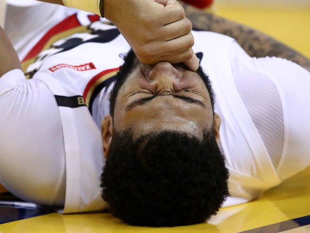 OAKLAND, CALIFORNIA - JANUARY 16: Anthony Davis #23 of the New Orleans Pelicans grimaces after being injured during their game against the Golden State Warriors at ORACLE Arena on January 16, 2019 in Oakland, California.