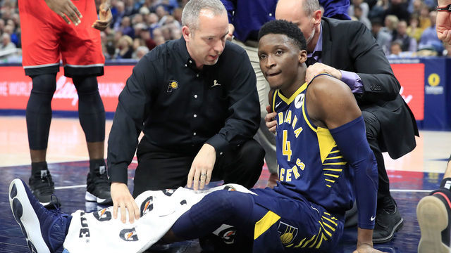 INDIANAPOLIS, INDIANA - JANUARY 23: Victor Oladipo #4 of the Indiana Pacers is attended to by medical staff after being injured in the second quarter of the game against the Toronto Raptors at Bankers Life Fieldhouse on January 23, 2019 in Indianapolis, Indiana.