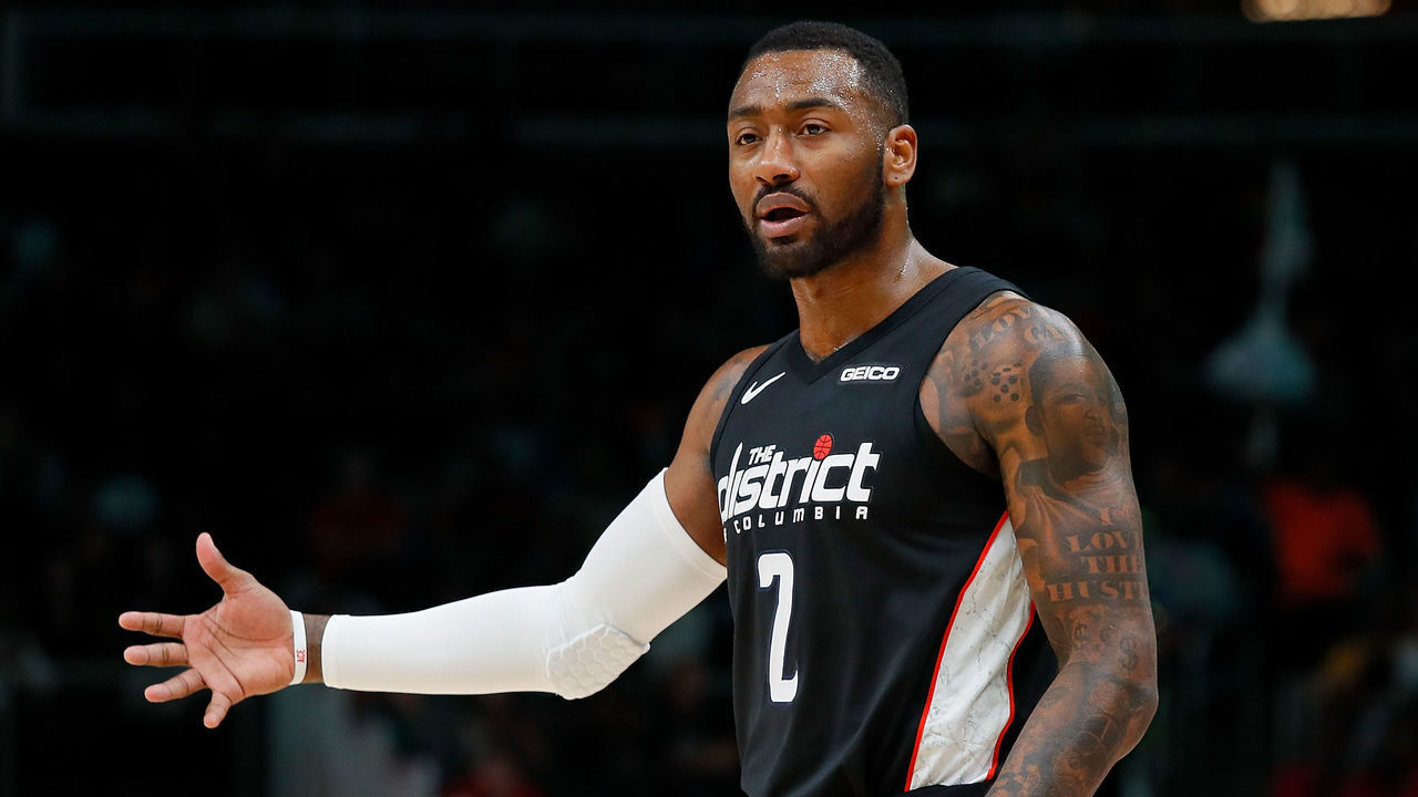 ATLANTA, GEORGIA - DECEMBER 18: John Wall #2 of the Washington Wizards reacts after Markieff Morris #5 was charged with his sixth foul against the Atlanta Hawks at State Farm Arena on December 18, 2018 in Atlanta, Georgia.