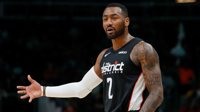 ATLANTA, GEORGIA - DECEMBER 18: John Wall #2 of the Washington Wizards reacts after Markieff Morris #5 was charged with his sixth foul against the Atlanta Hawks at State Farm Arena on December 18, 2018 in Atlanta, Georgia.