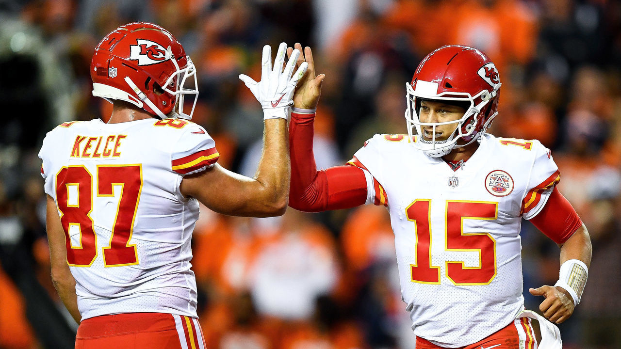 DENVER, CO - OCTOBER 1: Quarterback Patrick Mahomes #15 of the Kansas City Chiefs celebrates with tight end Travis Kelce #87 after scoring a second quarter rushing touchdown against the Denver Broncos at Broncos Stadium at Mile High on October 1, 2018 in Denver, Colorado.