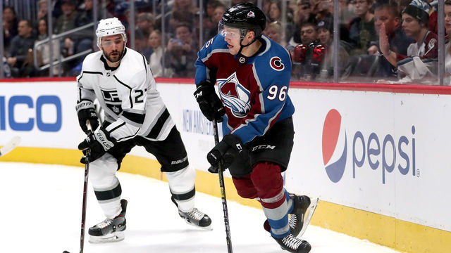 DENVER, COLORADO - JANUARY 19: Mikko Rantanen #96 of the Colorado Avalanche brings the puck brings the puck out from behind the net against Alec Martinez #27 of the Los Angeles Kings in the second period at the Pepsi Center on January 19, 2019 in Denver, Colorado.