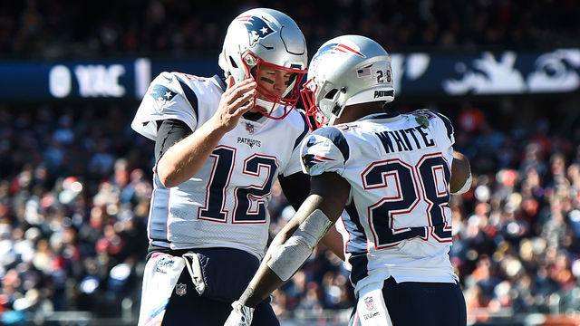 CHICAGO, IL - OCTOBER 21: Quarterback Tom Brady #12 of the New England Patriots and James White #28 celebrate after White scored against the Chicago Bears in the second quarter at Soldier Field on October 21, 2018 in Chicago, Illinois.