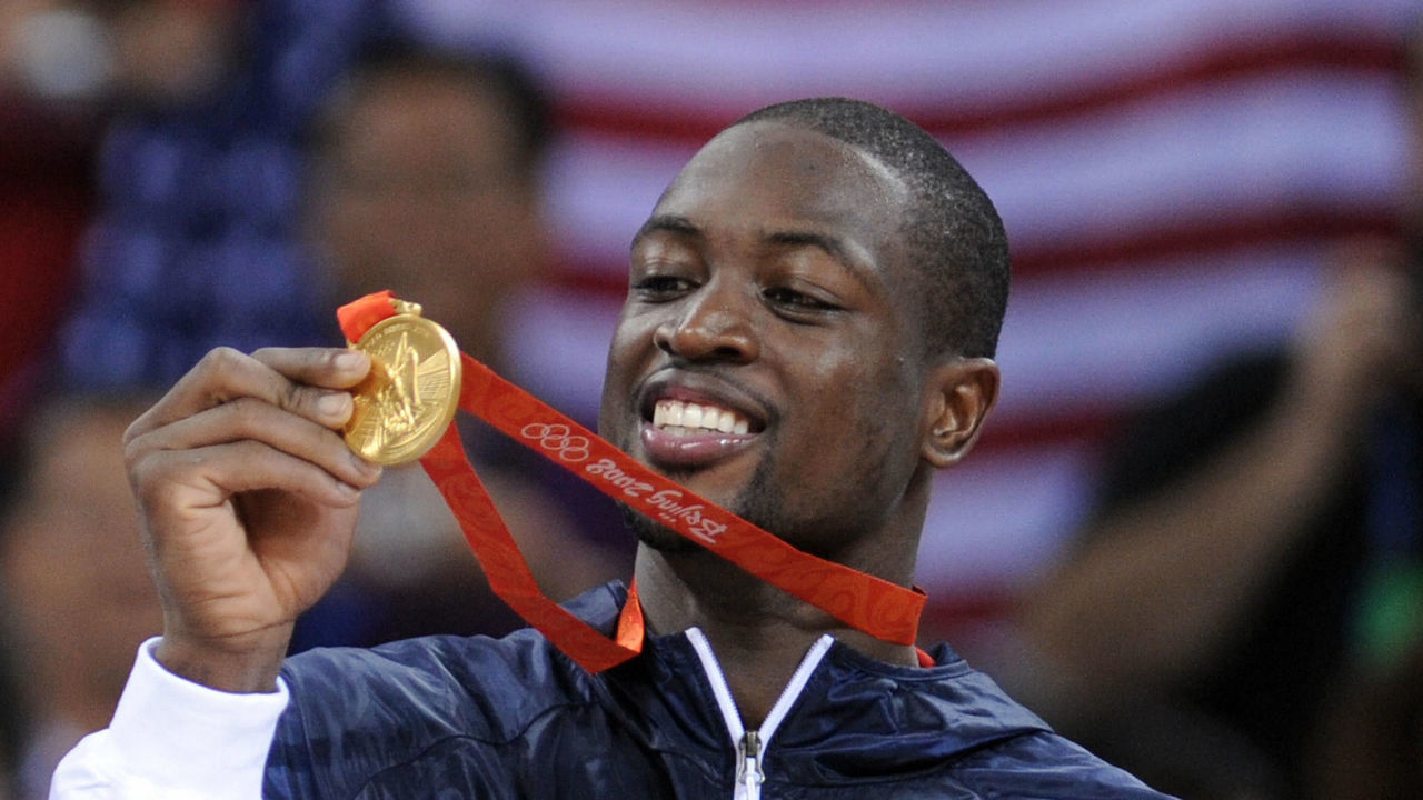 USA's Dwyane Wade shows his medals on the podium after the men's basketball gold medal match of the Beijing 2008 Olympic Games on August 24, 2008 at the Olympic basketball Arena in Beijing. The United States won the Olympic men's basketball gold medal defeating Spain 118-107. Argentina defeated Lithuania 87-75 in the bronze-medal game. AFP PHOTO / FILIPPO MONTEFORTE