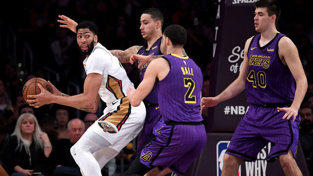 LOS ANGELES, CALIFORNIA - DECEMBER 21: Anthony Davis #23 of the New Orleans Pelicans is defended by Kyle Kuzma #0, Lonzo Ball #2 and Ivica Zubac #40 of the Los Angeles Lakers during a 112-104 Laker win at Staples Center on December 21, 2018 in Los Angeles, California.