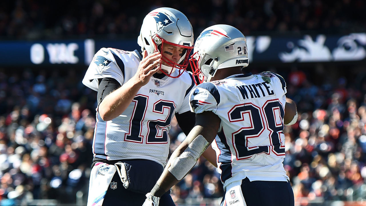 CHICAGO, IL - OCTOBER 21: Quarterback Tom Brady #12 of the New England Patriots and James White #28 celebrate after White scored against the Chicago Bears in the second quarter at Soldier Field on October 21, 2018 in Chicago, Illinois.