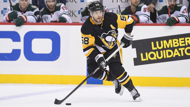 PITTSBURGH, PA - DECEMBER 20: Pittsburgh Penguins Defenseman Kris Letang (58) handles the puck during the first period in the NHL game between the Pittsburgh Penguins and the Minnesota Wild on December 20, 2018, at PPG Paints Arena in Pittsburgh, PA.