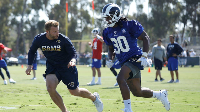 IRVINE, CA - JULY 30: Head Coach Sean McVay of the Los Angeles Rams runs through a drill with Todd Gurley #30 during Training Camp at Crawford Field on July 30, 2017 in Irvine, California.