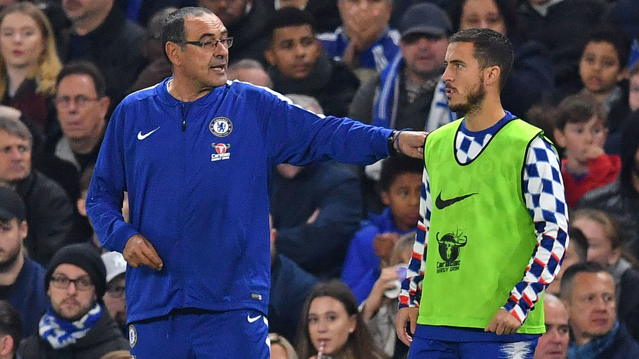 Chelsea's Italian head coach Maurizio Sarri (L) speaks with Chelsea's Belgian midfielder Eden Hazard (R) as he prepares to come on as a substitute during the English Premier League football match between Chelsea and Crystal Palace at Stamford Bridge in London on November 4, 2018.