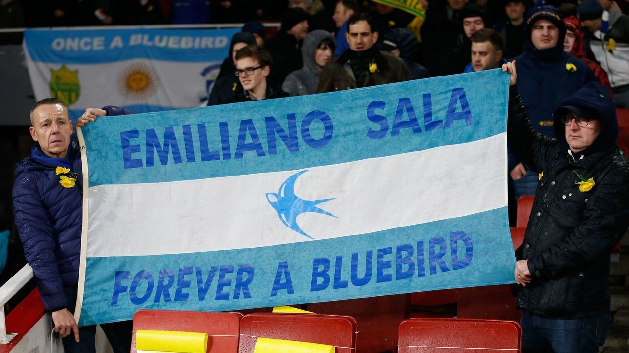 Fans hold up a banner in the colours of the Argentina flag honouring Cardiff's missing Argentinian player Emiliano Sala ahead of the English Premier League football match between Arsenal and Cardiff City at the Emirates Stadium in London on January 29, 2019. - A shipwreck hunter hired by the family of missing footballer Emiliano Sala to look for his missing plane said he was planning to begin an underwater search on Sunday. David Mearns of Bluewater Recoveries said on Monday, January 28, 2019, that two fishing boats were searching the sea around the island of Guernsey as part of the search.