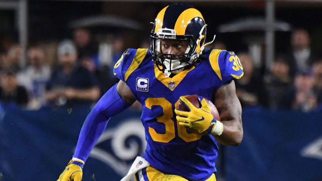 LOS ANGELES, CA - JANUARY 12: Running back Todd Gurley #30 of the Los Angeles Rams runs for a first down against thew Dallas Cowboys in the second half of a NFL playoff football game at the Los Angeles Memorial Coliseum on Saturday, January 12, 2018 in Los Angeles, California. Los Angeles Rams won 30-22.