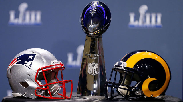 ATLANTA, GA - JANUARY 30: Detail of the Lombardi Trophy and the helmets of the New England Patriots (left) and the Los Angeles Rams prior to NFL Commissioner Roger Goodell speaking during a press conference during Super Bowl LIII Week at the NFL Media Center inside the Georgia World Congress Center on January 30, 2019 in Atlanta, Georgia.