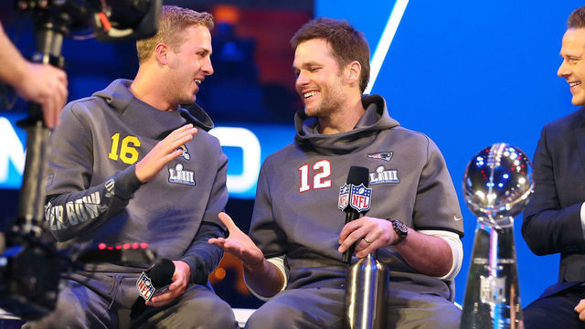 ATLANTA, GA - JANUARY 28: New England Patriots quarterback Tom Brady (12) and Los Angeles Rams quarterback Jared Goff (16) and the Vince Lombardi Trophy during Super Bowl Opening Night for the Los Angeles Rams on January 28, 2019 at State Farm Arena in Atlanta, GA.