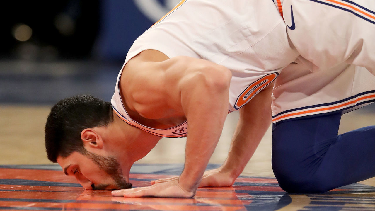 NEW YORK, NEW YORK - JANUARY 30: Enes Kanter #00 of the New York Knicks kisses the Knicks logo on the court as he enters the game in the third quarter against the Dallas Mavericks at Madison Square Garden on January 30, 2019 in New York City.