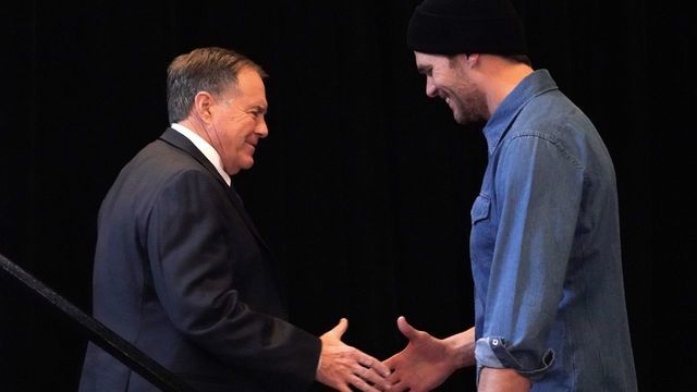 New England Patriots quarterback Tom Brady (R) greets head coach Bill Belichick (L) during a media availability at the Super Bowl Media Center at the World Congress Center in Atlanta, Georgia January 31, 2019. - The New England Patriots will meet the Los Angeles Ram at Super Bowl LII on Feb 3, 2019.
