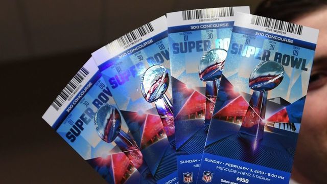 Michael Buchwald, NFL Senior Counsel, Legal, holds counterfeit game tickets during a press conference at the Super Bowl Media Center in Atlanta, Georgia, on January 31, 2019, as the The National Football League and law enforcement agencies announce the latest results of seizures of counterfeit game-related merchandise and tickets ahead of the Super Bowl LIII.
