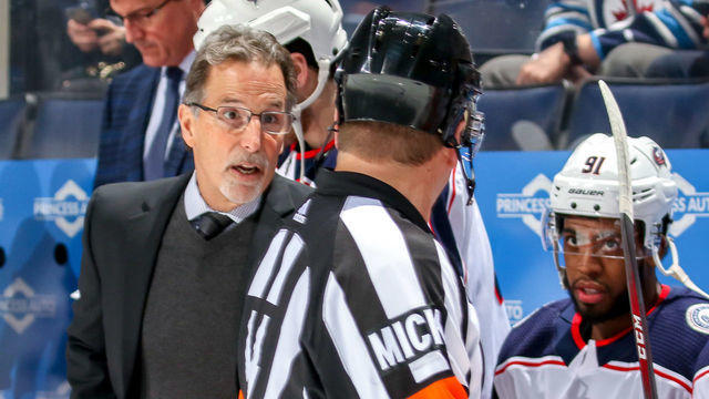 WINNIPEG, MB - JANUARY 31: Head Coach John Tortorella of the Columbus Blue Jackets chats with referee Trevor Hanson #14 prior to puck drop against the Winnipeg Jets at the Bell MTS Place on January 31, 2019 in Winnipeg, Manitoba, Canada.