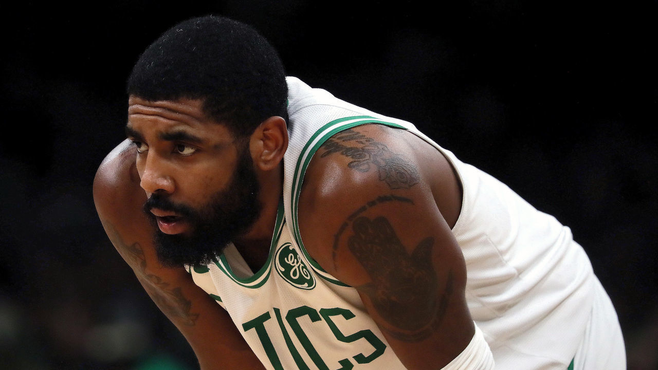BOSTON - JANUARY 18: Boston Celtics guard Kyrie Irving stands on the court. The Boston Celtics host the Memphis Grizzlies in a regular season NBA basketball game at TD Garden in Boston on Jan. 18, 2019.