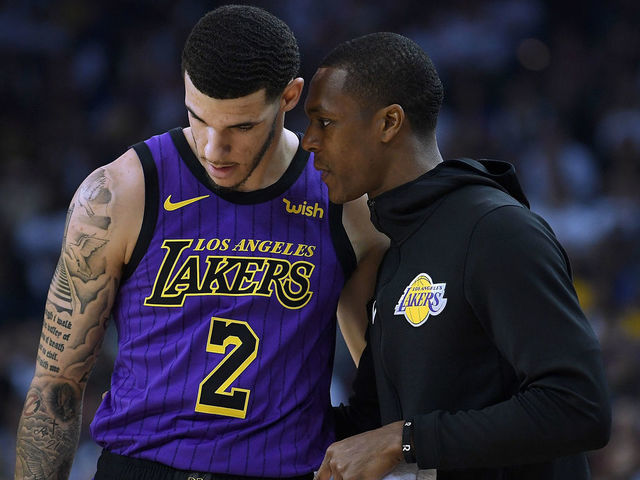 OAKLAND, CA - DECEMBER 25: Lonzo Ball #2 of the Los Angeles Lakers listens to teammate Rajon Rondo #9 against the Golden State Warriors during the first half of their NBA Basketball game at ORACLE Arena on December 25, 2018 in Oakland, California.