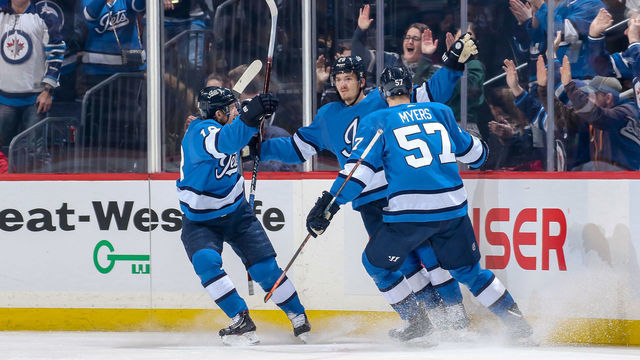 WINNIPEG, MB - FEBRUARY 2: Bryan Little #18, Jack Roslovic #28 and Tyler Myers #57 of the Winnipeg Jets celebrate a first period goal against the Anaheim Ducks at the Bell MTS Place on February 2, 2019 in Winnipeg, Manitoba, Canada.