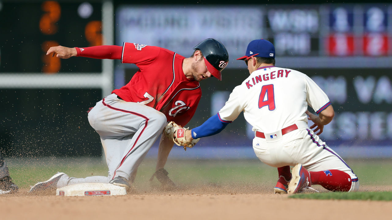 PHILADELPHIA, PA - JULY 1: Scott Kingery #4 of the Philadelphia Phillies tags out Trea Turner #7 of the Washington Nationals on a stolen base attempt in the 13th inning during a game at Citizens Bank Park on July 1, 2018 in Philadelphia, Pennsylvania. The Phillies won 4-3 in 13 innings.