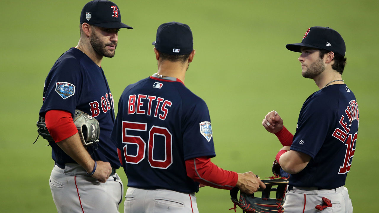 LOS ANGELES, CA - OCTOBER 28: J.D. Martinez #28, Mookie Betts #50 and Andrew Benintendi #16 of the Boston Red Sox meet in the outfield during a pitching change during Game 5 of the 2018 World Series against the Los Angeles Dodgers at Dodger Stadium on Sunday, October 28, 2018 in Los Angeles, California.