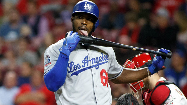 CINCINNATI, OH - SEPTEMBER 10: Yasiel Puig #66 of the Los Angeles Dodgers licks his bat in the game against the Cincinnati Reds at Great American Ball Park on September 10, 2018 in Cincinnati, Ohio.