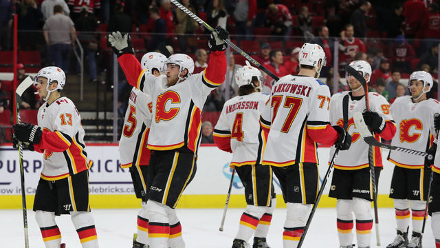 RALEIGH, NC - FEBRUARY 03: Calgary Flames center Elias Lindholm (28) former Carolina Hurricanes player makes fun of the Storm Surge cheer at the end of the 3rd period of the Carolina Hurricanes game versus the Calgary Flames on February 3rd, 2019 at PNC Arena in Raleigh, NC.