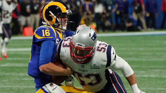 Quarterback for the Los Angeles Rams Jared Goff (L) is tackled by linebacker for the New England Patriots Kyle Van Noy during Super Bowl LIII between the New England Patriots and the Los Angeles Rams at Mercedes-Benz Stadium in Atlanta, Georgia, on February 3, 2019.
