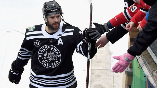 SOUTH BEND, IN - JANUARY 01: Brent Seabrook #7 of the Chicago Blackhawks fist bumps fans as he walks off the field after the 2019 Bridgestone NHL Winter Classic game against the Boston Bruins at Notre Dame Stadium on January 1, 2019 in South Bend, Indiana.
