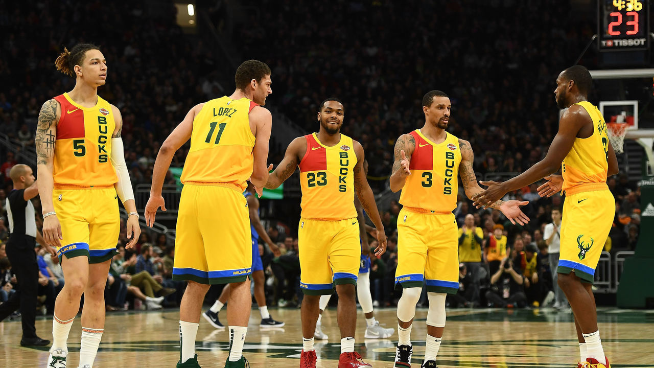 MILWAUKEE, WISCONSIN - JANUARY 21: D.J. Wilson #5, Brook Lopez #11, Sterling Brown #23, George Hill #3 and Khris Middleton #22 of the Milwaukee Bucks walk to the bench for a timeout during a game against the Dallas Mavericks at Fiserv Forum on January 21, 2019 in Milwaukee, Wisconsin.