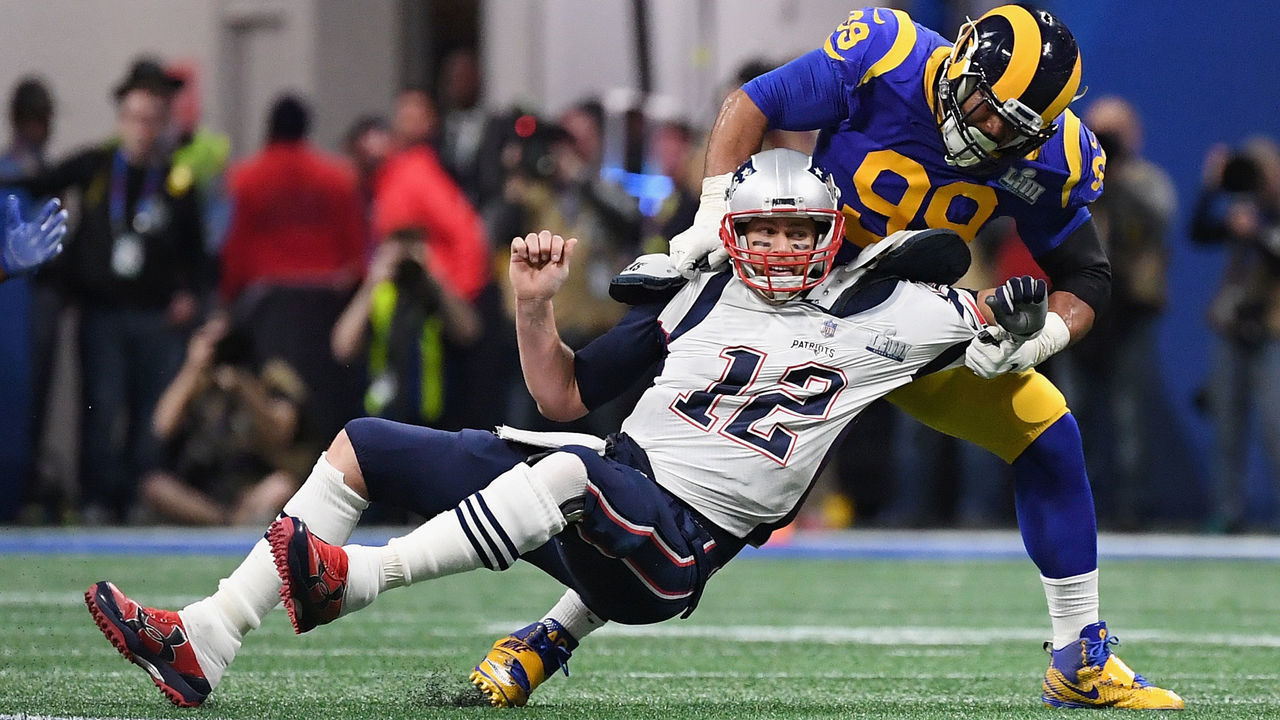 ATLANTA, GA - FEBRUARY 03: Tom Brady #12 of the New England Patriots is sacked by Aaron Donald #99 of the Los Angeles Rams in the first quarter during Super Bowl LIII at Mercedes-Benz Stadium on February 3, 2019 in Atlanta, Georgia.