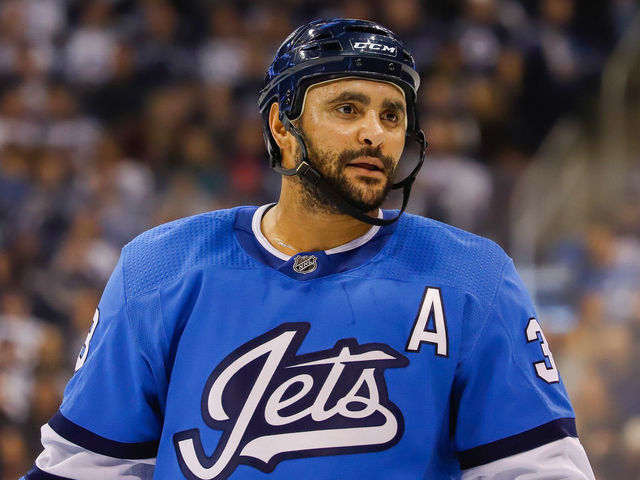 WINNIPEG, MB - DECEMBER 29: Dustin Byfuglien #33 of the Winnipeg Jets looks on during a second period stoppage in play against the Minnesota Wild at the Bell MTS Place on December 29, 2018 in Winnipeg, Manitoba, Canada. The Wild defeated the Jets 3-1.