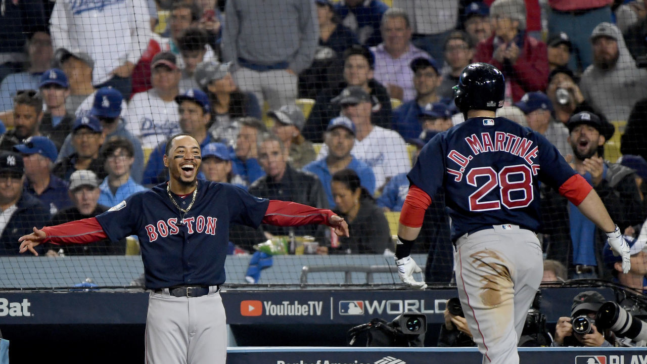 LOS ANGELES, CA - OCTOBER 28: J.D. Martinez #28 of the Boston Red Sox is congratulated by his teammate Mookie Betts #50 after his seventh inning home run against the Los Angeles Dodgers in Game Five of the 2018 World Series at Dodger Stadium on October 28, 2018 in Los Angeles, California.