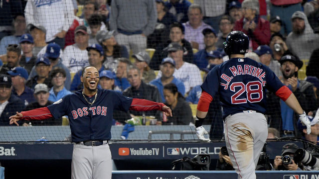 LOS ANGELES, CA - OCTOBER 28: J.D. Martinez #28 of the Boston Red Sox is congratulated by his teammate Mookie Betts #50 after his seventh inning home run against the Los Angeles Dodgers in Game Five of the 2018 World Series at Dodger Stadium on October 28, 2018 in Los Angeles, California.