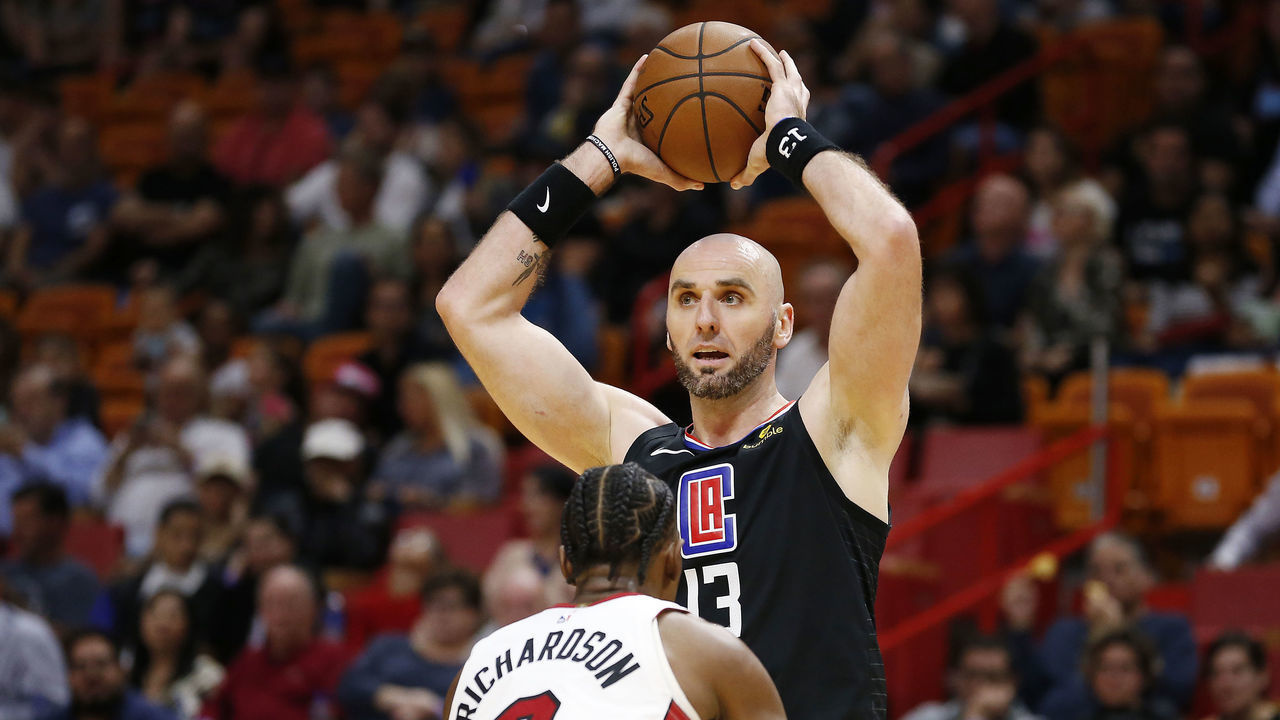 MIAMI, FLORIDA - JANUARY 23: Marcin Gortat #13 of the LA Clippers looks to pass over Josh Richardson #0 of the Miami Heat at American Airlines Arena on January 23, 2019 in Miami, Florida.