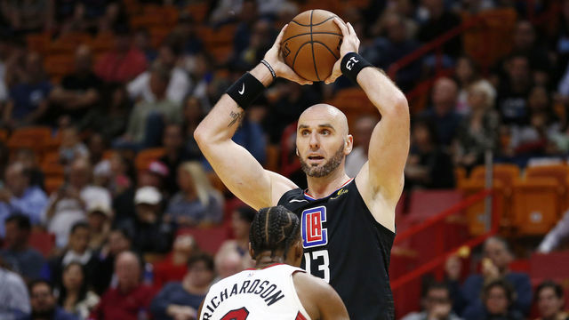 MIAMI, FLORIDA - JANUARY 23: Marcin Gortat #13 of the LA Clippers looks to pass over Josh Richardson #0 of the Miami Heat at American Airlines Arena on January 23, 2019 in Miami, Florida.