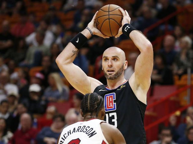 MIAMI, FLORIDA - JANUARY 23: Marcin Gortat #13 of the LA Clippers looks to pass over Josh Richardson #0 of the Miami Heat at American Airlines Arena on January 23, 2019 in Miami, Florida.