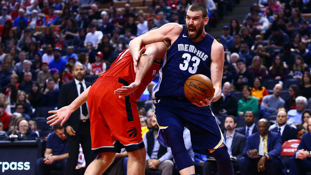 TORONTO, ON - FEBRUARY 4: Marc Gasol #33 of the Memphis Grizzlies drives to the basket as Jonas Valanciunas #17 of the Toronto Raptors defends during the first half of an NBA game at Air Canada Centre on February 4, 2018 in Toronto, Canada.