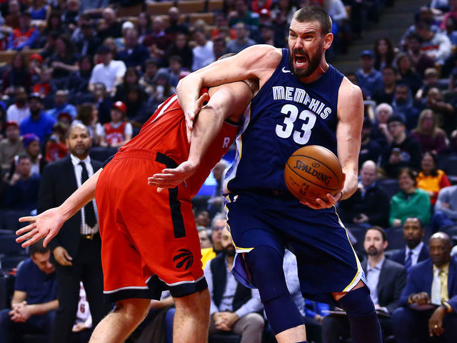 TORONTO, ON - FEBRUARY 4: Marc Gasol #33 of the Memphis Grizzlies drives to the basket as Jonas Valanciunas #17 of the Toronto Raptors defends during the first half of an NBA game at Air Canada Centre on February 4, 2018 in Toronto, Canada.