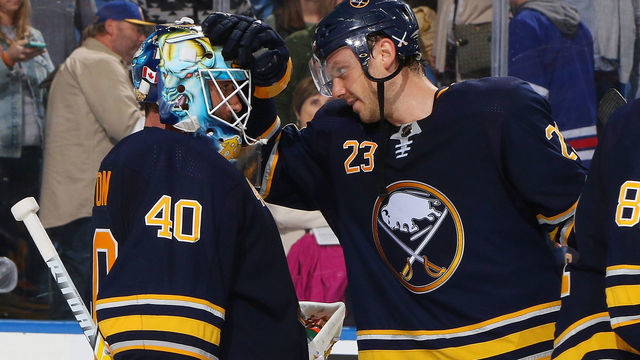 BUFFALO, NY - OCTOBER 6: Sam Reinhart #23 congradulates Carter Hutton #40 of the Buffalo Sabres following their 3-1 victory against the New York Rangers in an NHL game on October 6, 2018 at KeyBank Center in Buffalo, New York.