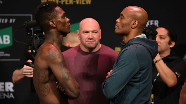 MELBOURNE, AUSTRALIA - FEBRUARY 09: (L-R) Israel Adesanya of New Zealand and Anderson Silva of Brazil face off during the UFC 234 weigh-in at Rod Laver Arena on February 09, 2019 in the Melbourne Australia.
