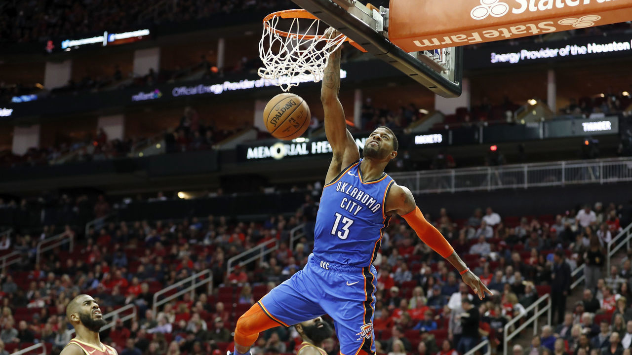 HOUSTON, TX - FEBRUARY 09: Paul George #13 of the Oklahoma City Thunder dunks the ball in the second half defended by James Harden #13 of the Houston Rockets and Chris Paul #3 at Toyota Center on February 9, 2019 in Houston, Texas.