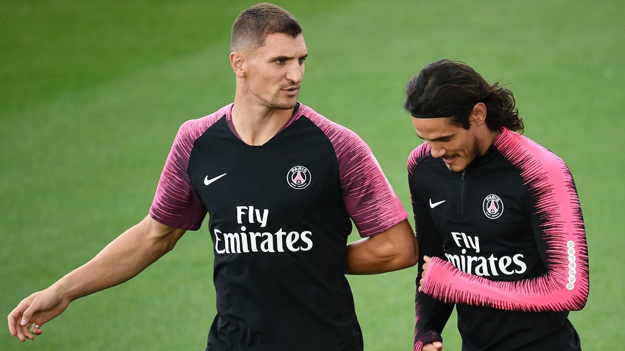 Paris Saint-Germain's Belgian defender Thomas Meunier (L) jokes with Paris Saint-Germain's Uruguayan forward Edinson Cavani (R) as they take part in a training session of the Paris Saint-Germain football team on August 24, 2018 at the Camp des Loges, in Saint-Germain-en-Laye, on the outskirts of Paris, on the eve of their French L1 football match.