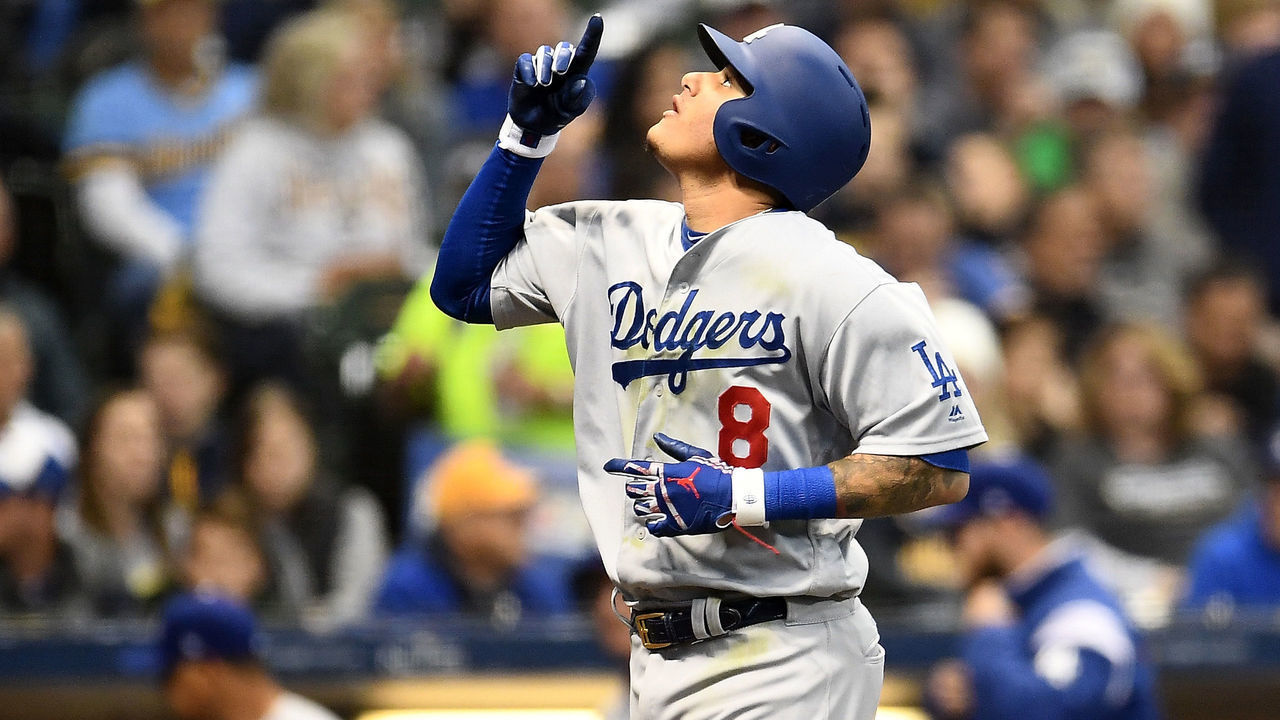 MILWAUKEE, WI - OCTOBER 12: Manny Machado #8 of the Los Angeles Dodgers celebrates after hitting a solo home run against Gio Gonzalez #47 of the Milwaukee Brewers during the second inning in Game One of the National League Championship Series at Miller Park on October 12, 2018 in Milwaukee, Wisconsin.