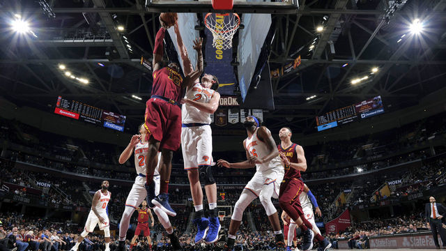 CLEVELAND, OH - FEBRUARY 11: David Nwaba #12 of the Cleveland Cavaliers is blocked by Luke Kornet #2 of the New York Knicks on February 11, 2019 at Quicken Loans Arena in Cleveland, Ohio. NOTE TO USER: User expressly acknowledges and agrees that, by downloading and/or using this photograph, user is consenting to the terms and conditions of the Getty Images License Agreement. Mandatory Copyright Notice: Copyright 2019 NBAE